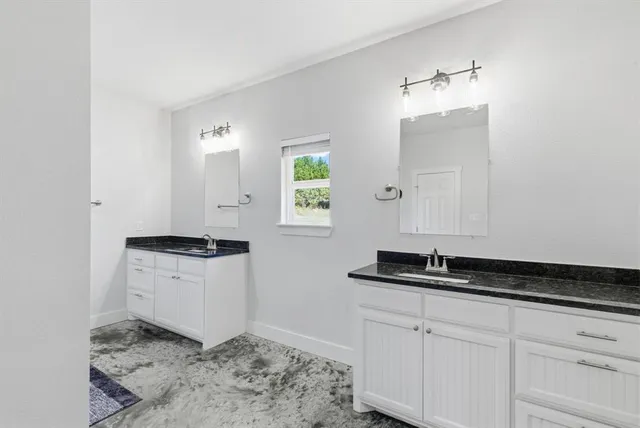 a kitchen with granite countertop a sink and a stove