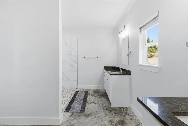 a bathroom with a sink and a window