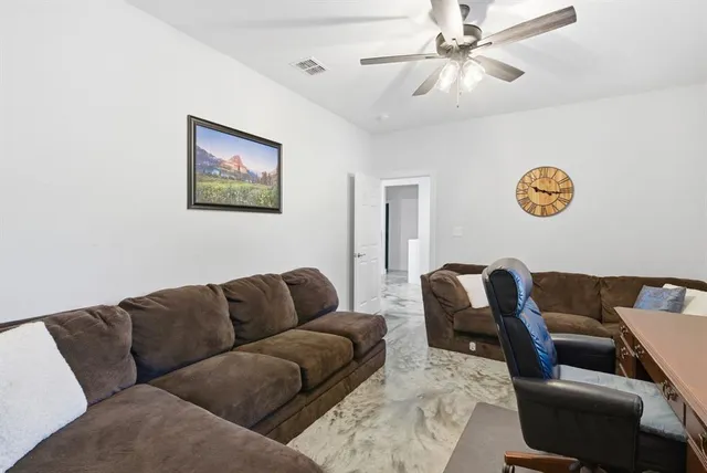 a blue couch sitting next to a blue wall with a rug