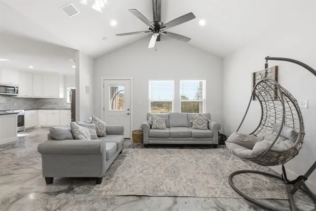 a living room with furniture and a large window