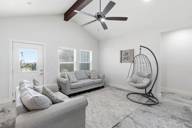 a living room with furniture a window and a chandelier