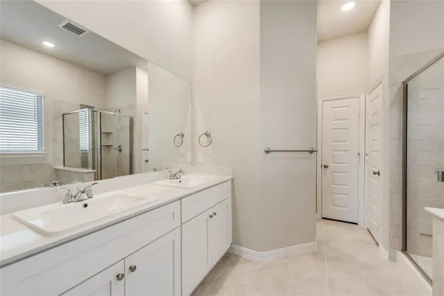a bathroom with a double vanity sink mirror and