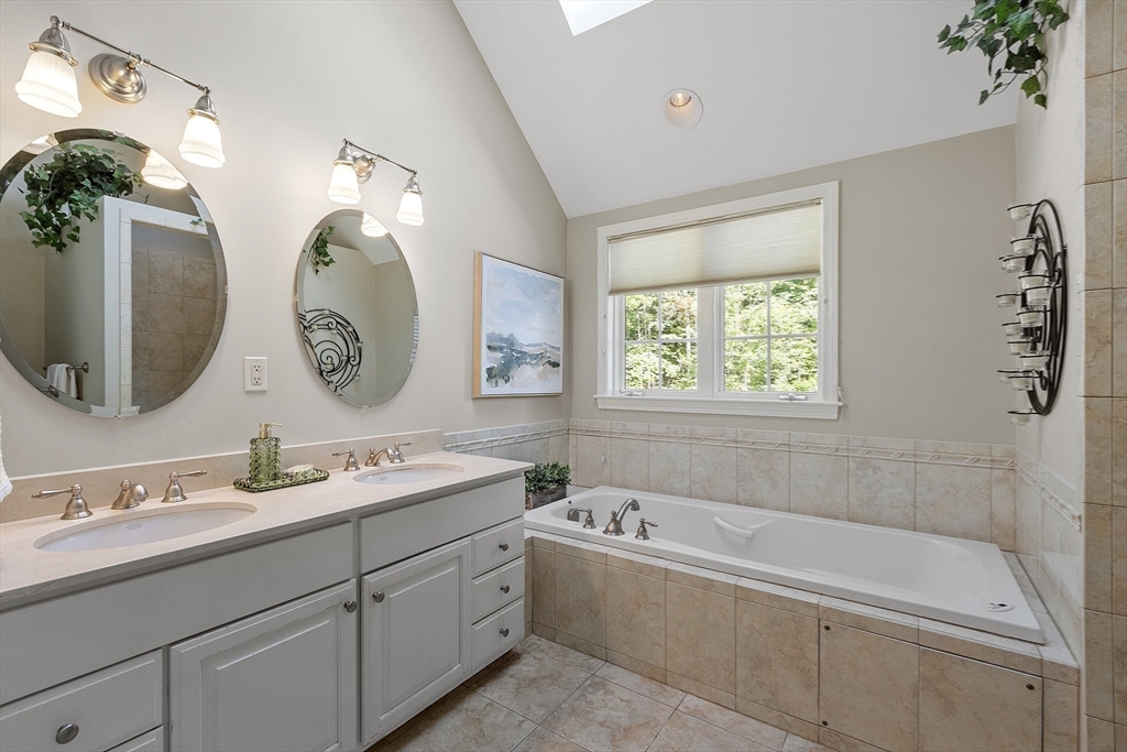 62 Waite Road Boxborough, MA 01719 - Photo 28 of 41 a bathroom with a tub sink and mirror