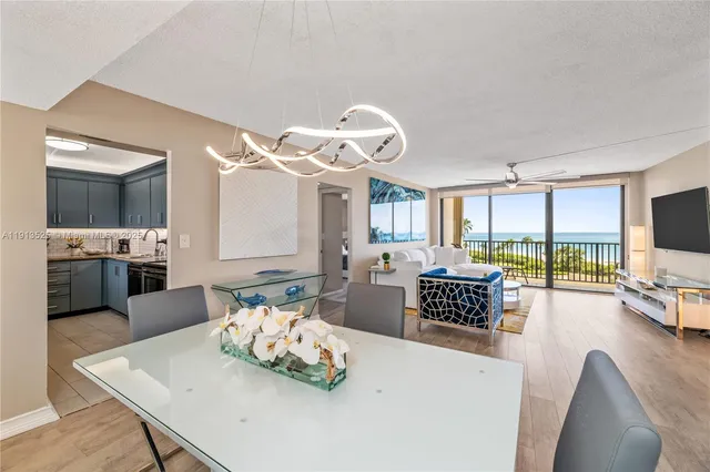 a living room with furniture flat screen tv and outdoor view