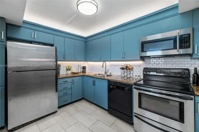 a kitchen with granite countertop stainless steel appliances and wooden cabinets