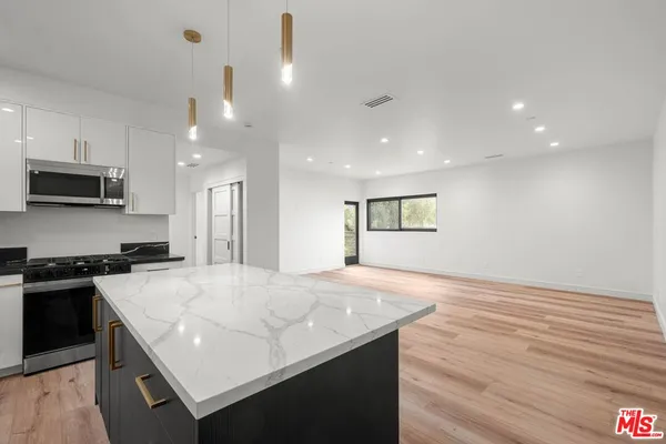 a kitchen with a stove and a sink