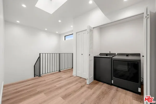 a view of a livingroom with wooden floor and a fireplace