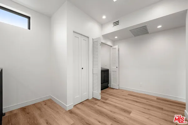 a view of a room with wooden floor