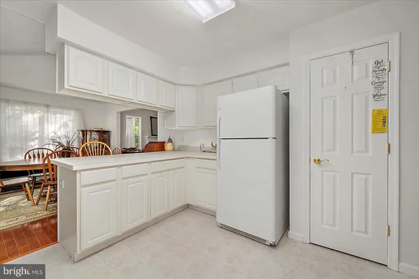 a view of a a dining room with furniture window and wooden floor