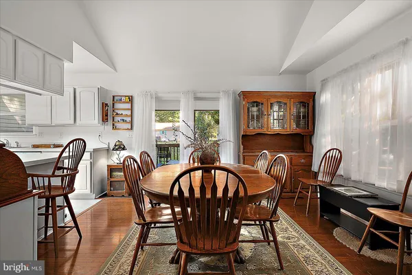 a dining room with furniture and wooden floor