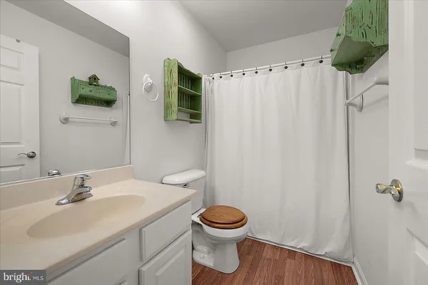 a view of room with furniture and wooden floor