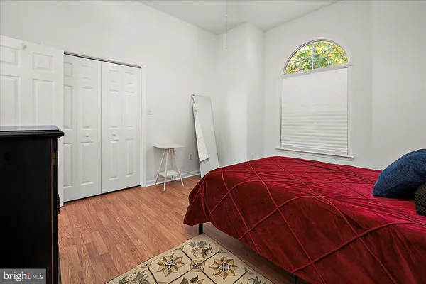 a bedroom with a bed and a closet