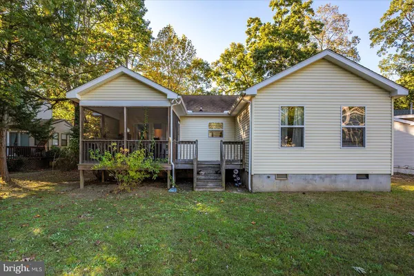 a front view of house with yard and outdoor seating
