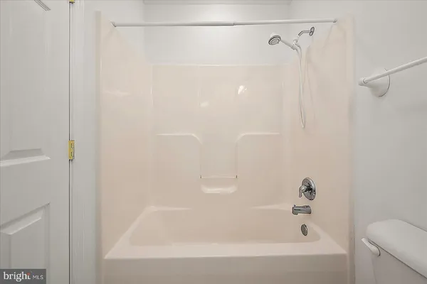 a bedroom with a bed and a wooden floor