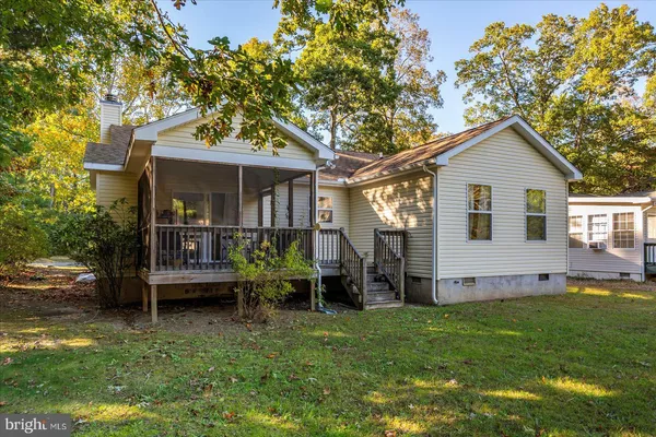 a view of a field with tree in front of it