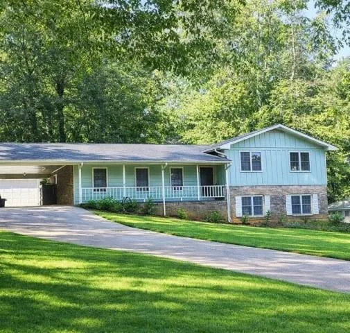 a front view of a house with a garden