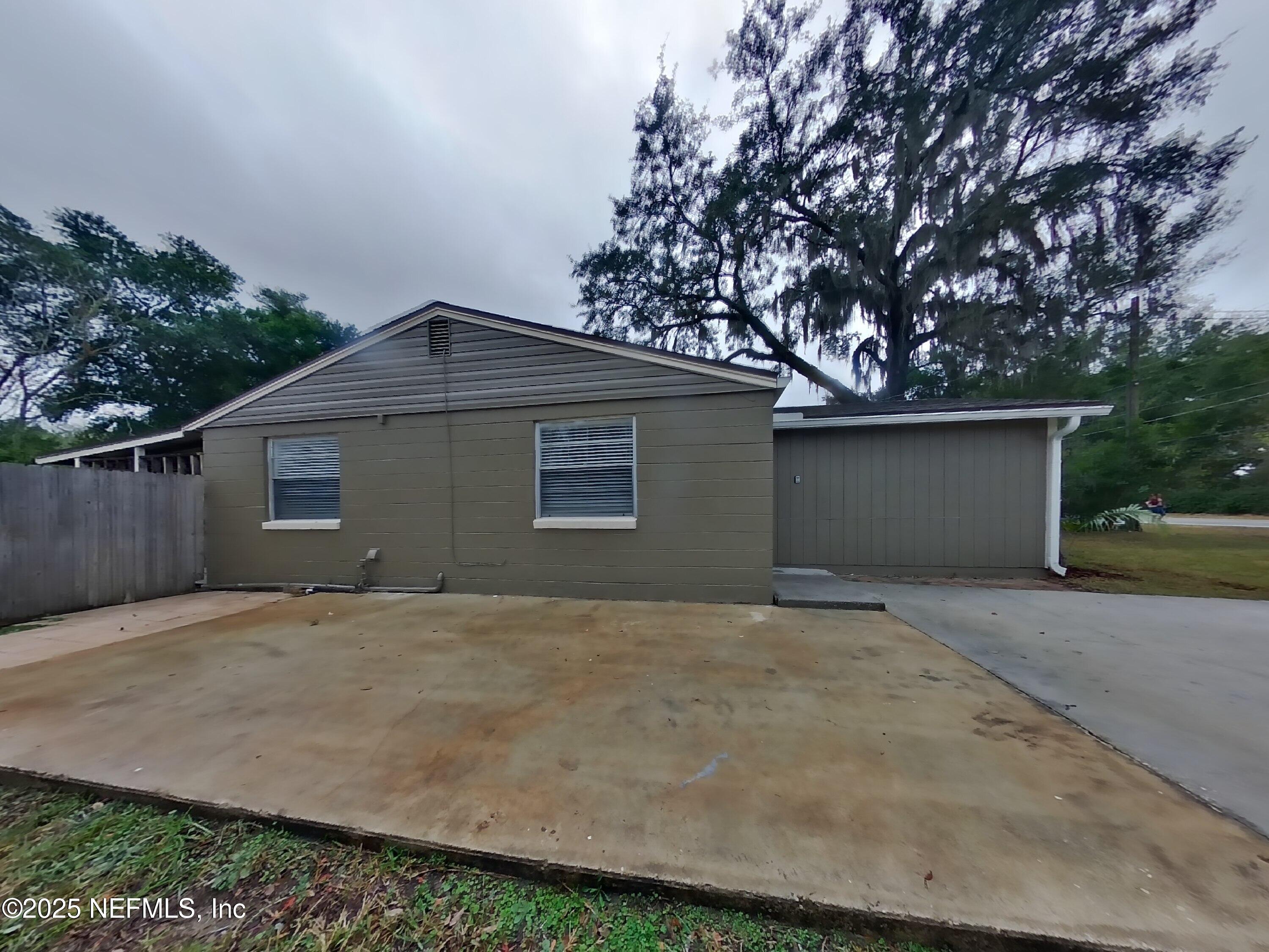 5807 Ricker Road Jacksonville, FL 32244 - Photo 12 of 13 a front view of a house with a yard and garage