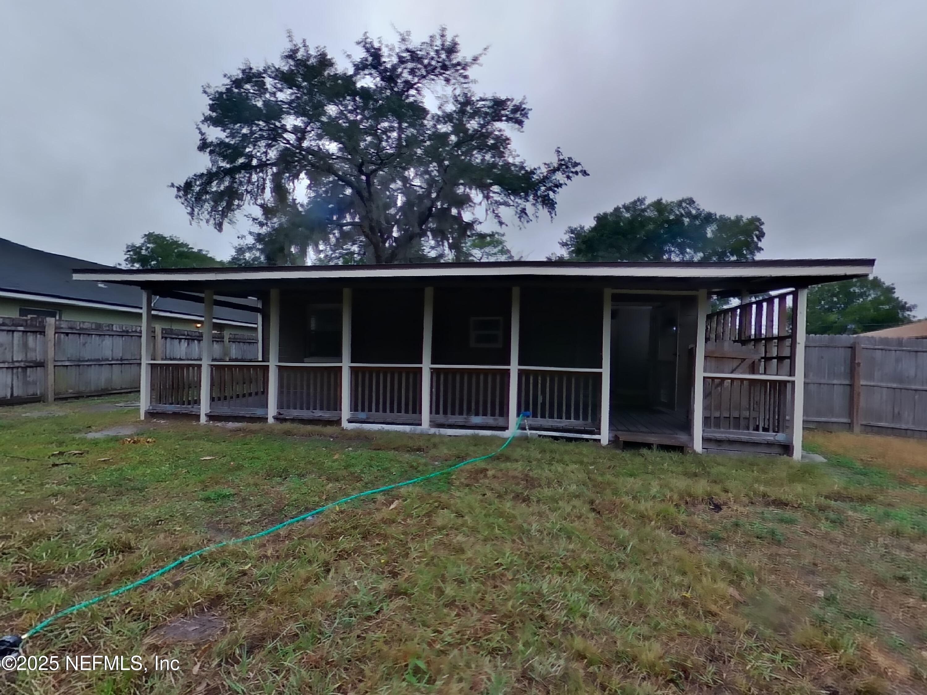 5807 Ricker Road Jacksonville, FL 32244 - Photo 13 of 13 a view of a house with a yard and that has a large tree