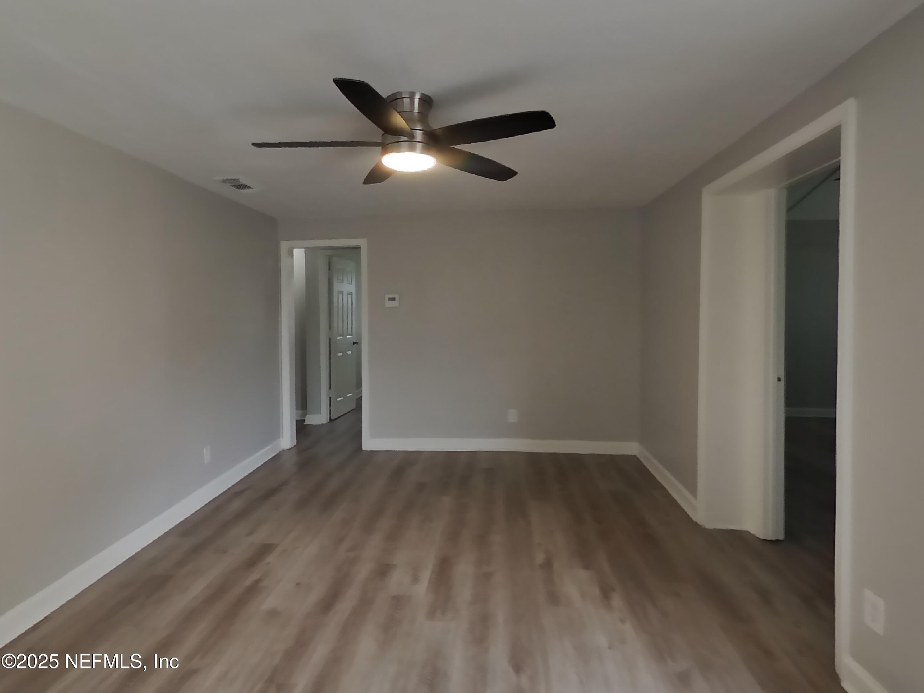 5807 Ricker Road Jacksonville, FL 32244 - Photo 2 of 13 a view of an empty room with wooden floor