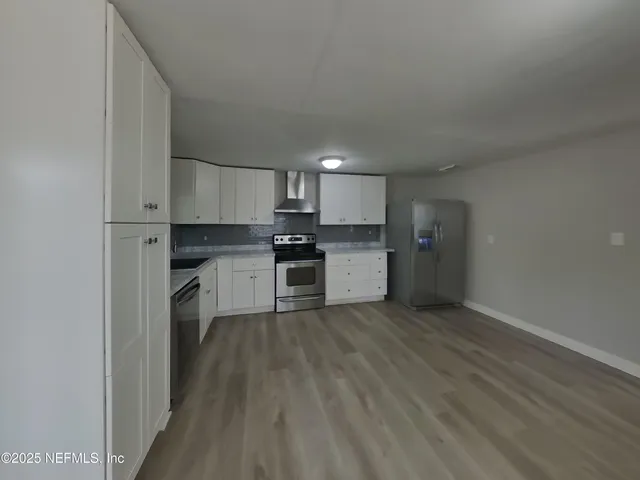 a kitchen with wooden cabinets and stainless steel appliances