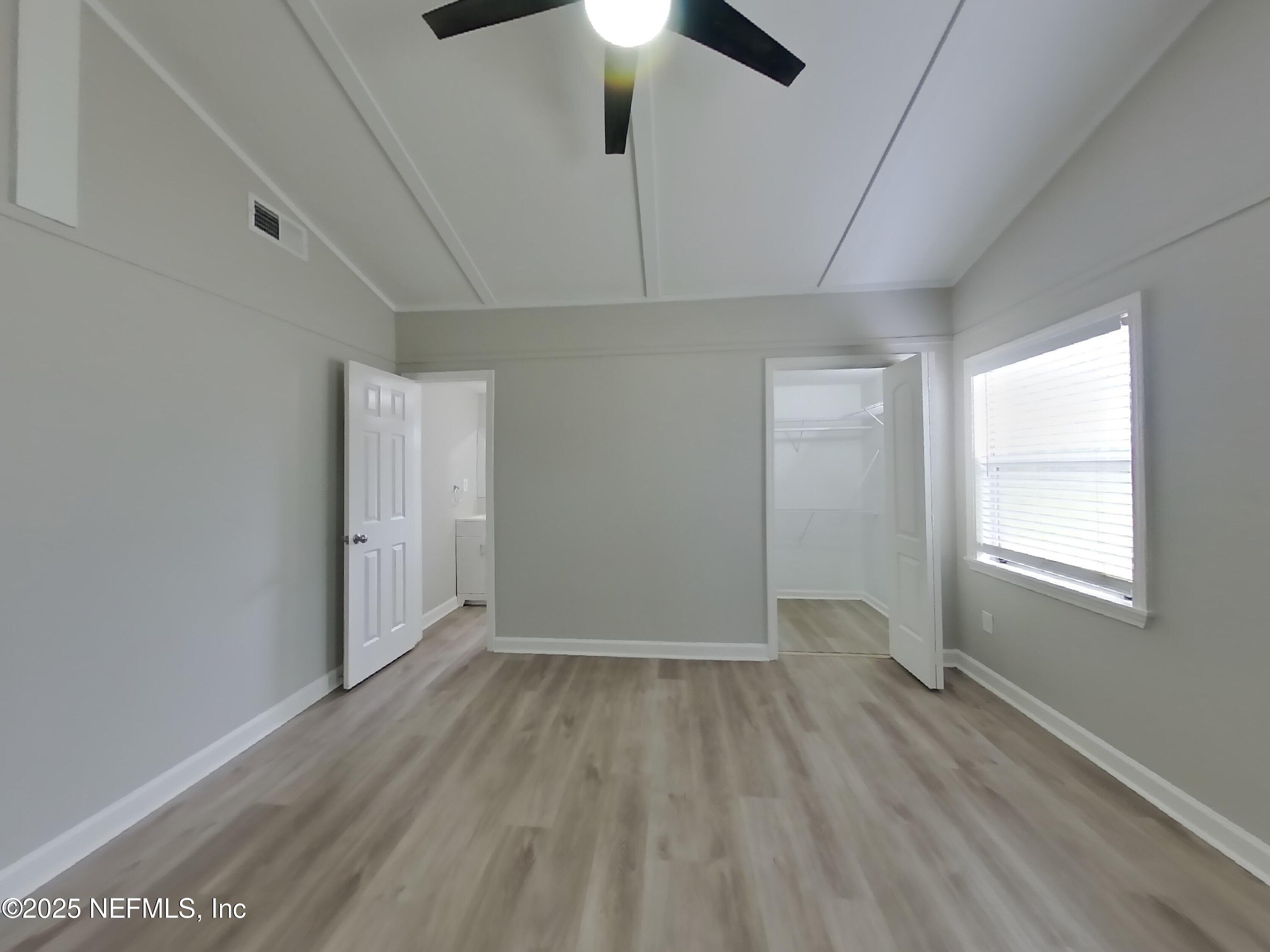 5807 Ricker Road Jacksonville, FL 32244 - Photo 4 of 13 wooden floor in an empty room with a window