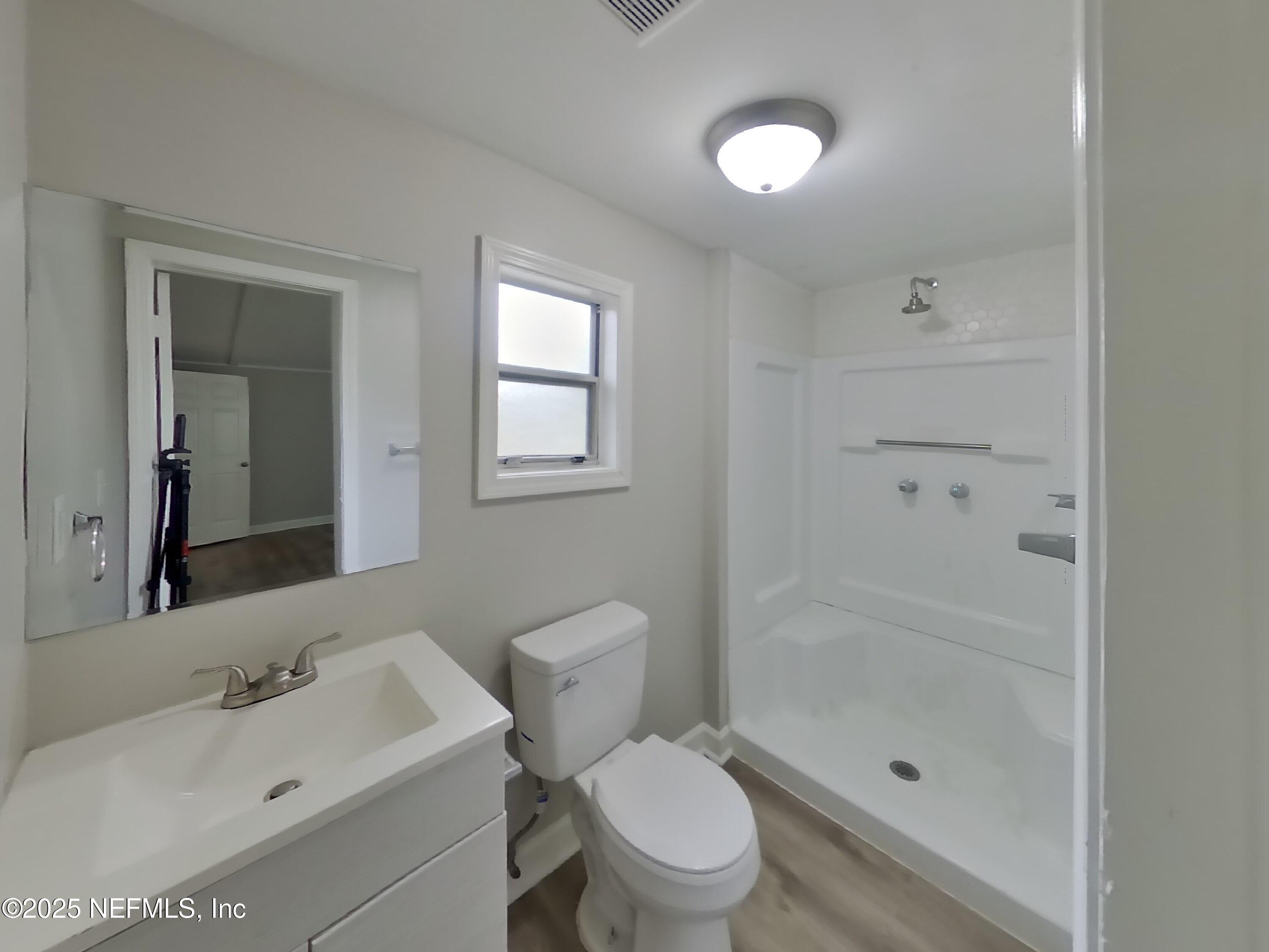 5807 Ricker Road Jacksonville, FL 32244 - Photo 5 of 13 a bathroom with a sink toilet and shower