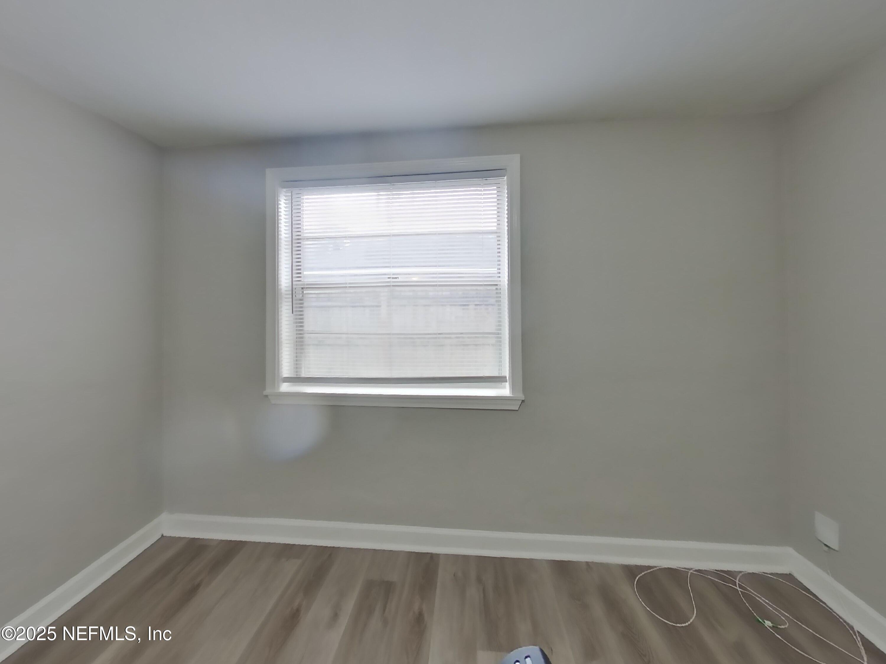 5807 Ricker Road Jacksonville, FL 32244 - Photo 8 of 13 a view of a room with wooden floor and a window