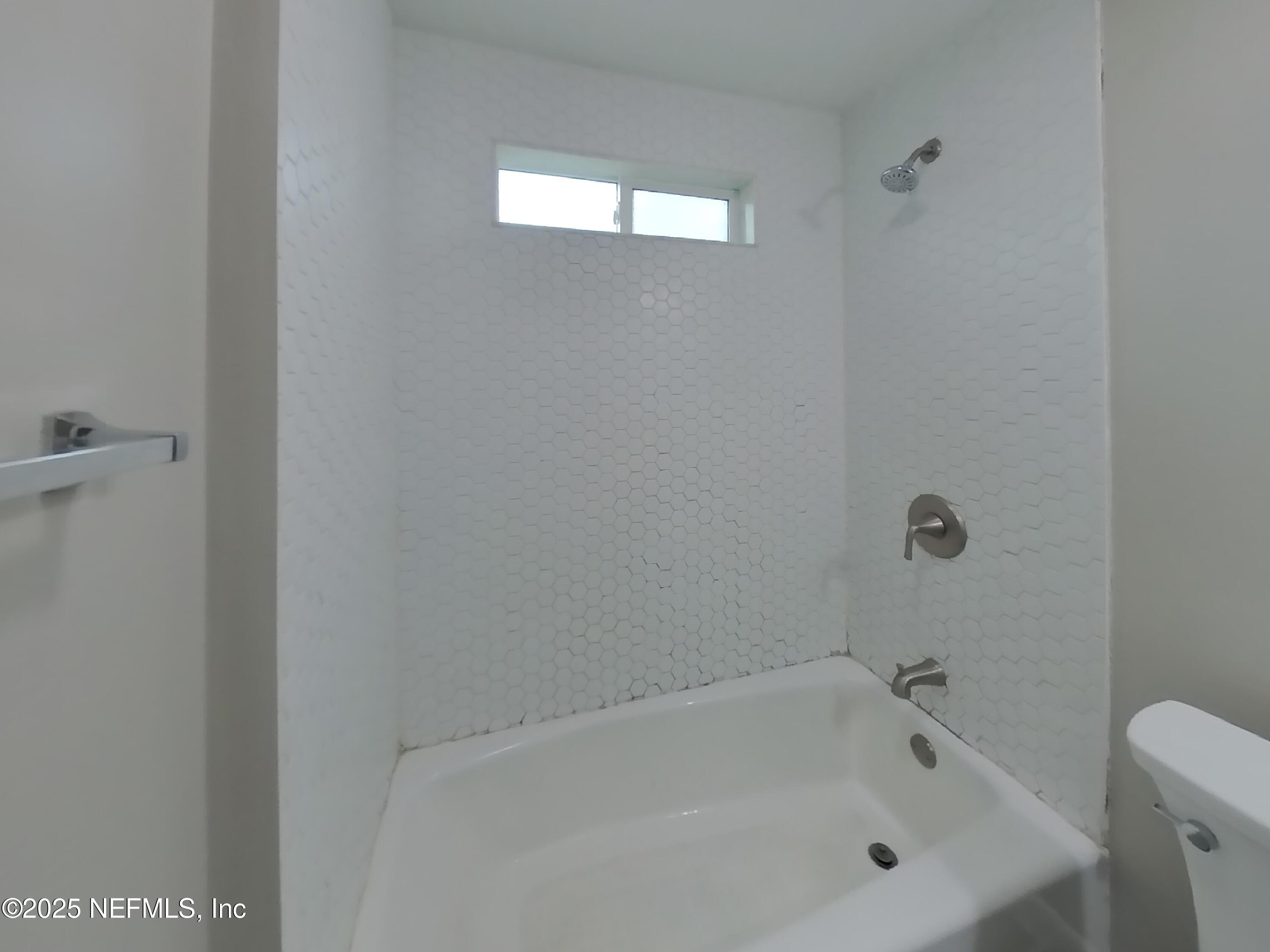 5807 Ricker Road Jacksonville, FL 32244 - Photo 10 of 13 a bathroom with a bathtub