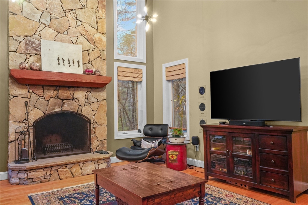 20 Barnside Road Boxford, MA 01921 - Photo 11 of 42 a living room with furniture a flat screen tv and a fireplace