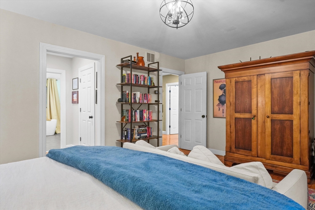 20 Barnside Road Boxford, MA 01921 - Photo 16 of 42 a bedroom with a large bed and a chandelier