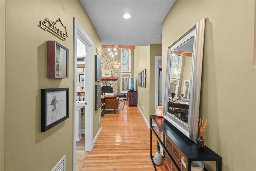 20 Barnside Road Boxford, MA 01921 - Photo 20 of 42 a view of a hallway with wooden floor and furniture