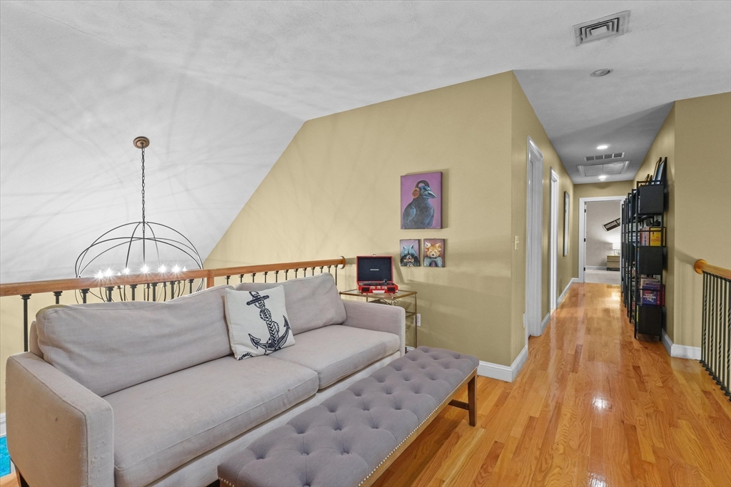 20 Barnside Road Boxford, MA 01921 - Photo 22 of 42 a living room with furniture and a chandelier