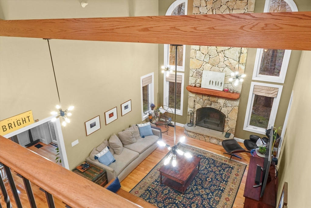 20 Barnside Road Boxford, MA 01921 - Photo 24 of 42 a living room with furniture a fireplace and a floor to ceiling window