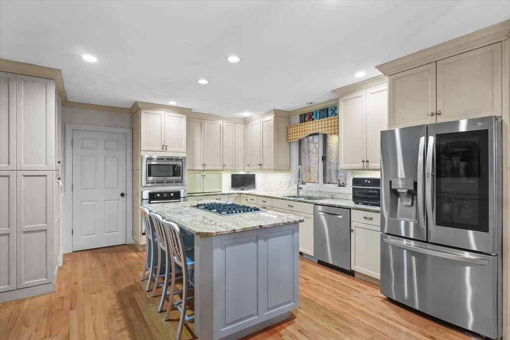 20 Barnside Road Boxford, MA 01921 - Photo 4 of 42 a kitchen with stainless steel appliances granite countertop a refrigerator a stove and a sink