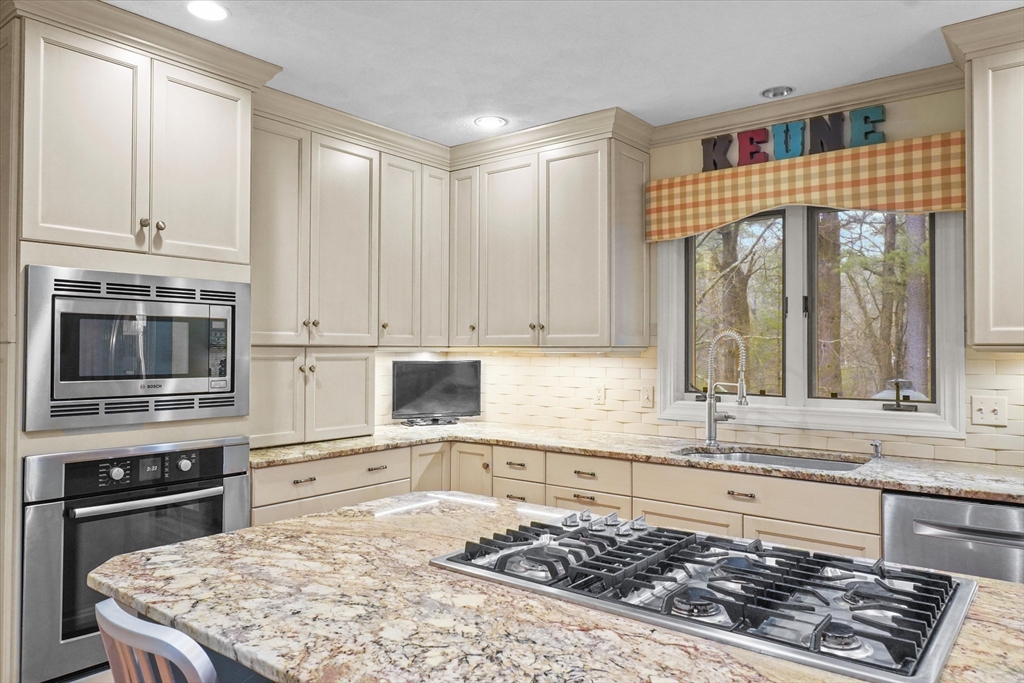 20 Barnside Road Boxford, MA 01921 - Photo 6 of 42 a kitchen with stainless steel appliances granite countertop a stove a sink and a microwave