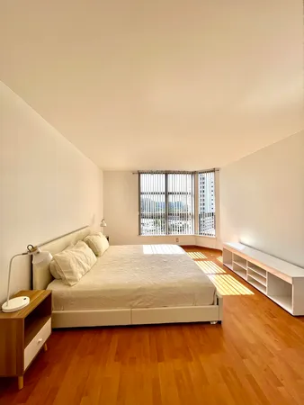 a bedroom with a bed and window