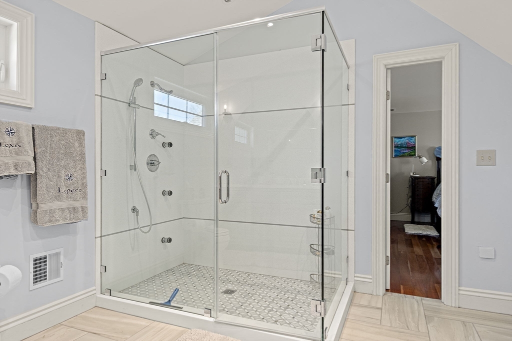 53 Linden Road Hampton Falls, NH 03844 - Photo 21 of 42 a bathroom with a glass shower door and a window
