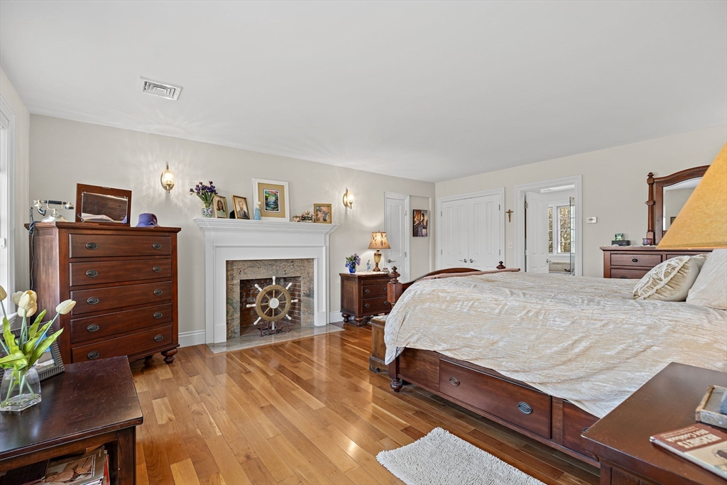53 Linden Road Hampton Falls, NH 03844 - Photo 24 of 42 a bed room with a bed and a fireplace