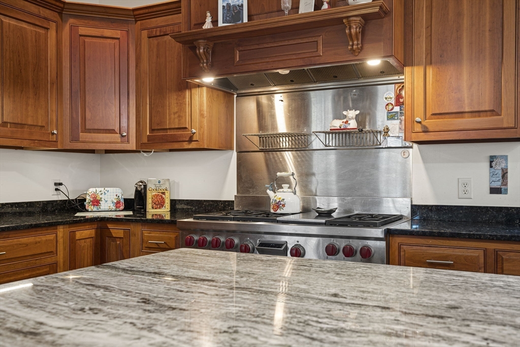 53 Linden Road Hampton Falls, NH 03844 - Photo 8 of 42 a kitchen with stainless steel appliances granite countertop a stove and a sink