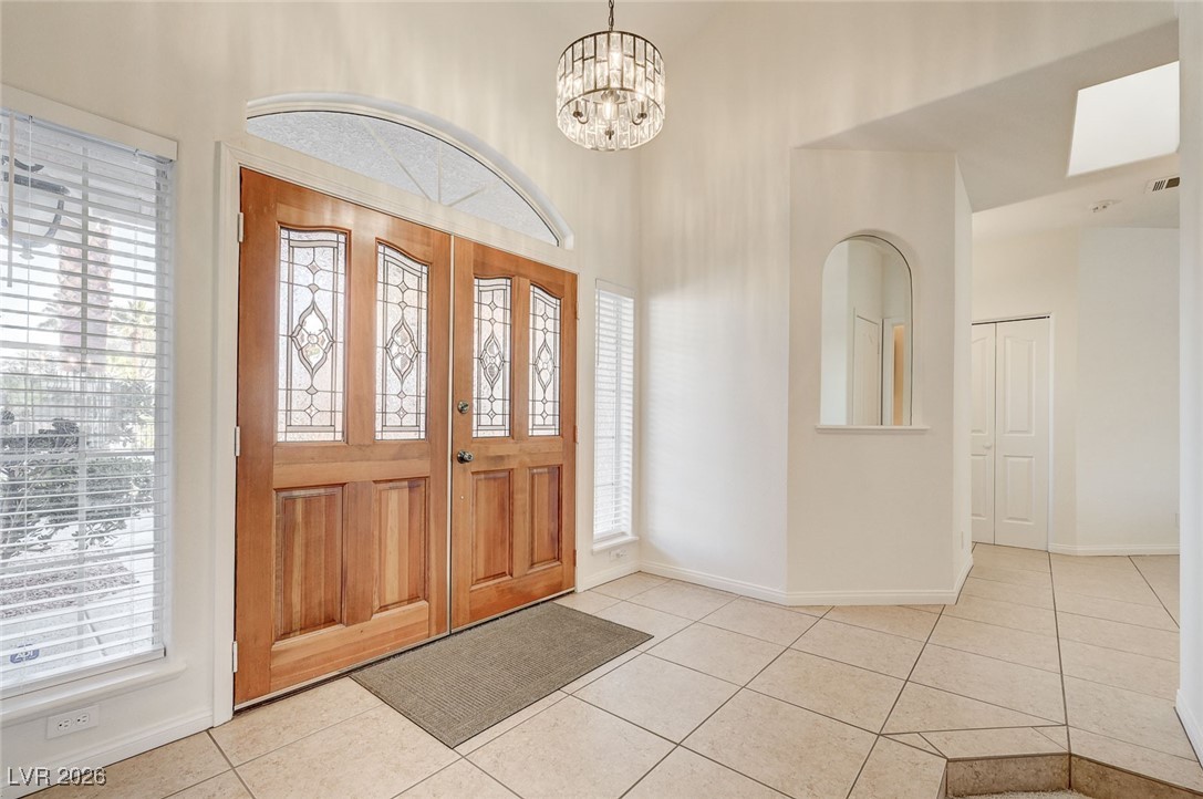 2955 El Camino Road Las Vegas, NV 89146 - Photo 41 of 99 Entrance foyer featuring a chandelier, light tile patterned flooring, and plenty of natural light