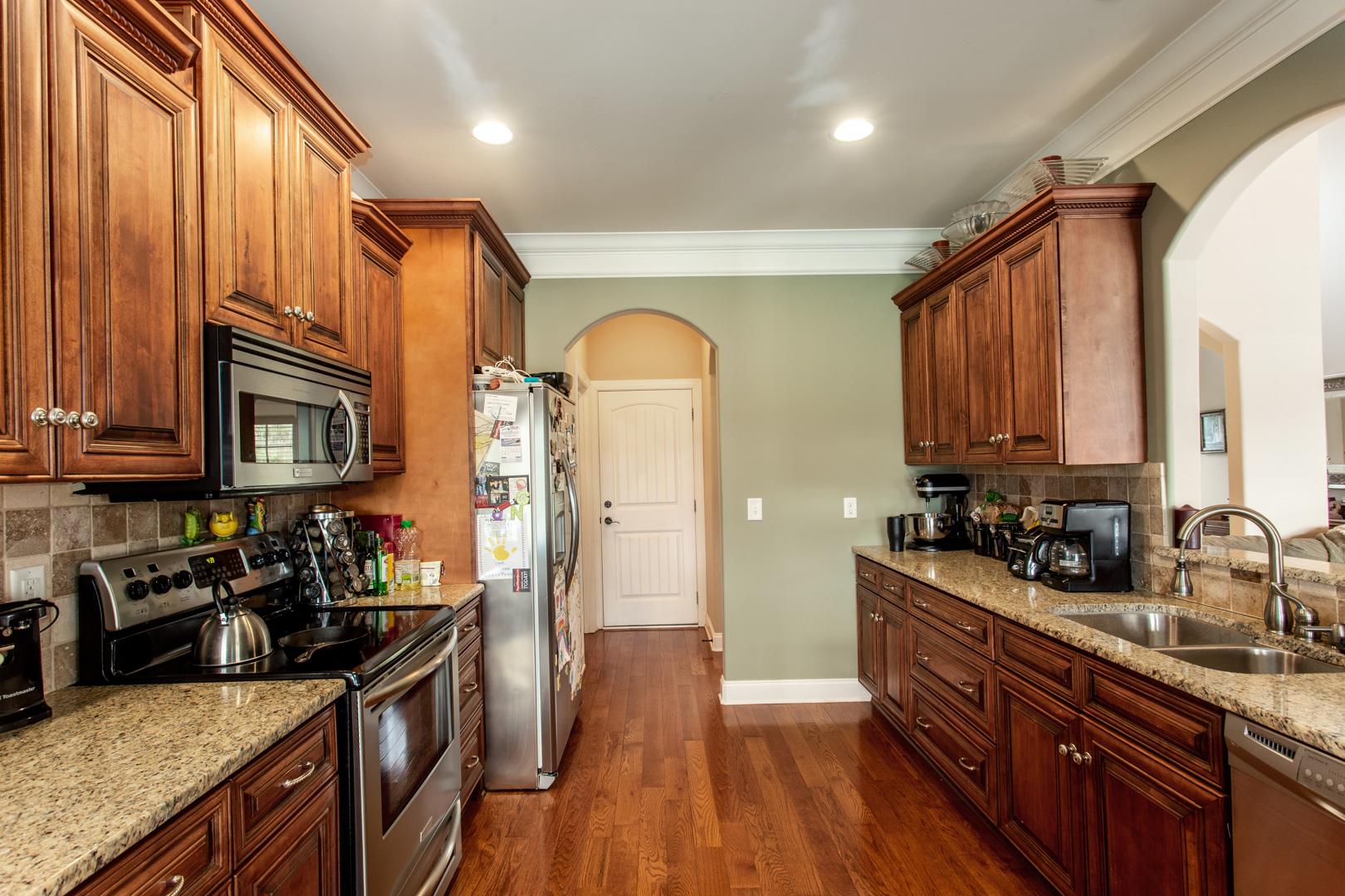 245 Dunaway Road Lebanon, TN 37090 - Photo 12 of 30 a kitchen with stainless steel appliances granite countertop a sink a stove and a wooden floors