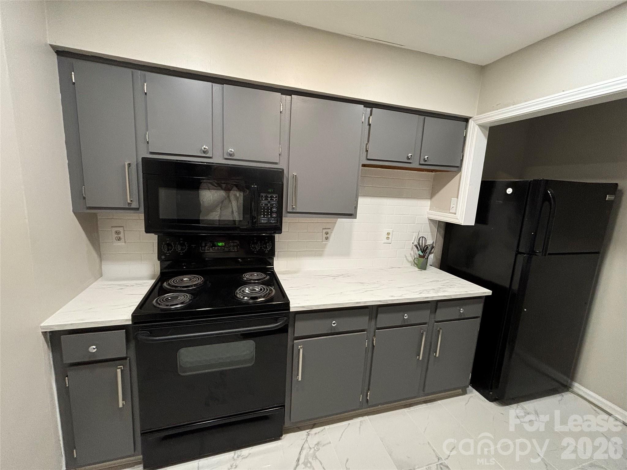 11040 Harrowfield Road Charlotte, NC 28226 - Photo 3 of 14 a kitchen with a sink appliances and cabinets