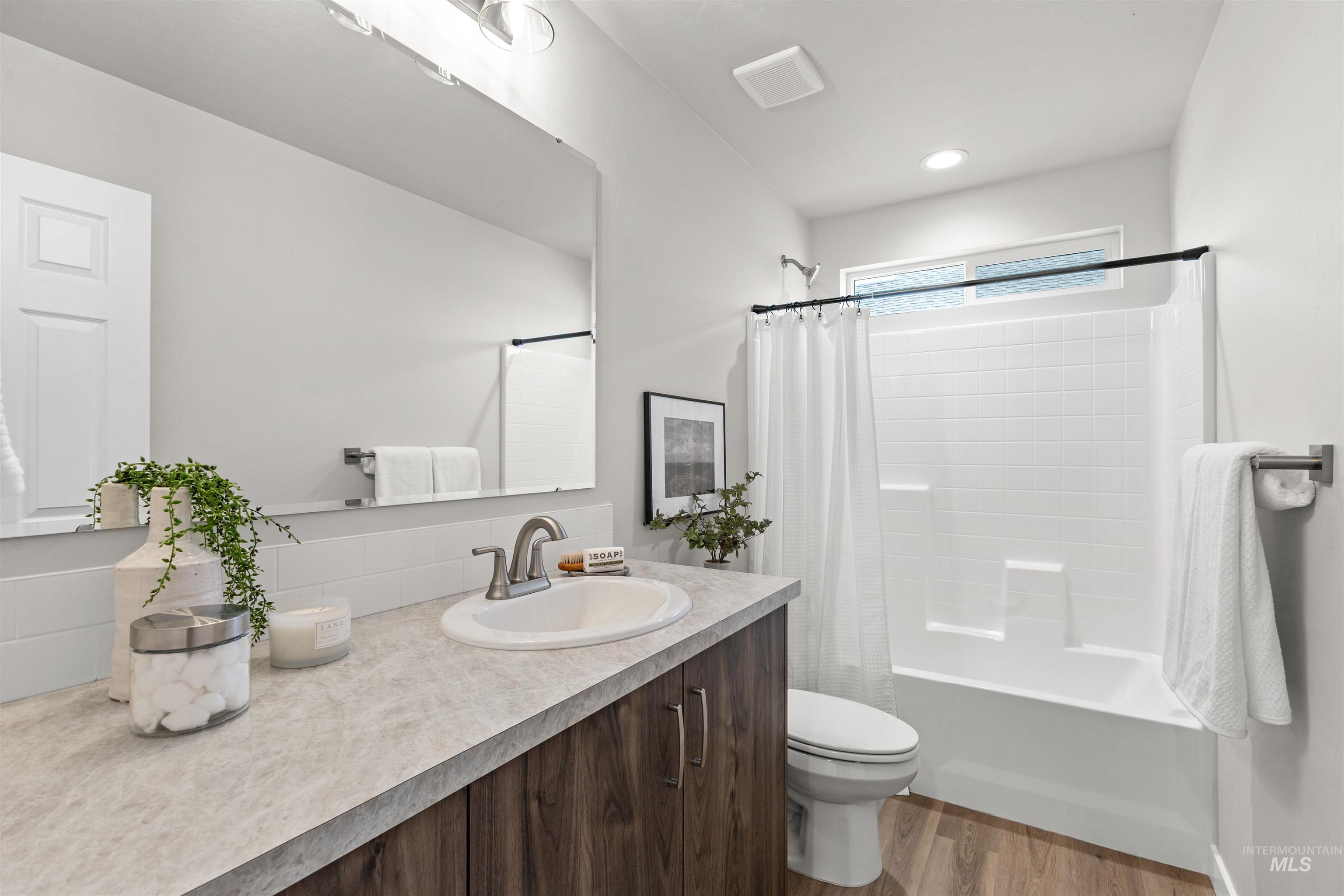 2534 West Fallon Loop Nampa, ID 83651 - Photo 21 of 28 Full bath featuring vanity, dark wood-style flooring, and shower / bath combo
