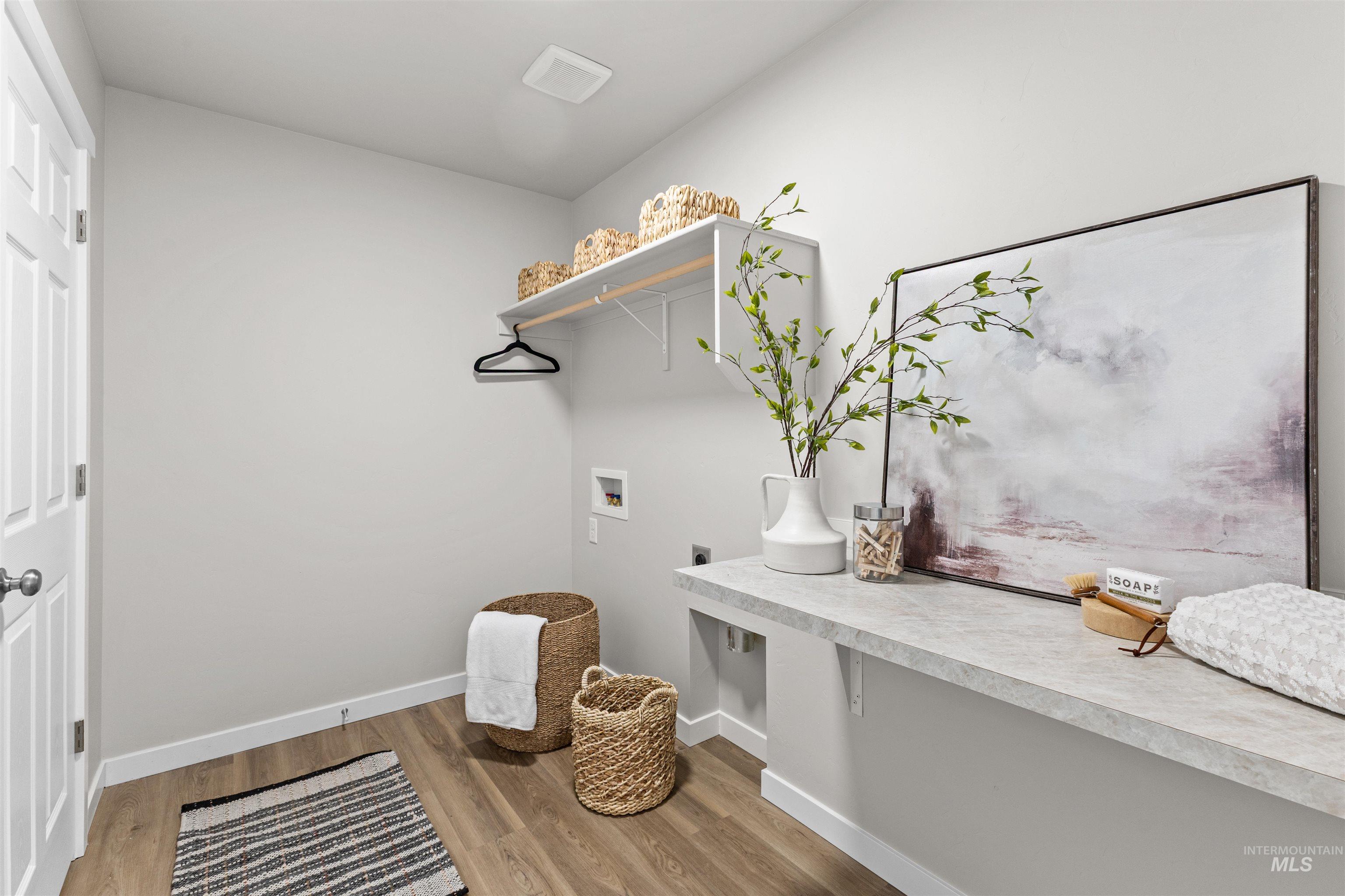 2534 West Fallon Loop Nampa, ID 83651 - Photo 22 of 28 Laundry room featuring light wood-style flooring, hookup for a washing machine, and electric dryer hookup