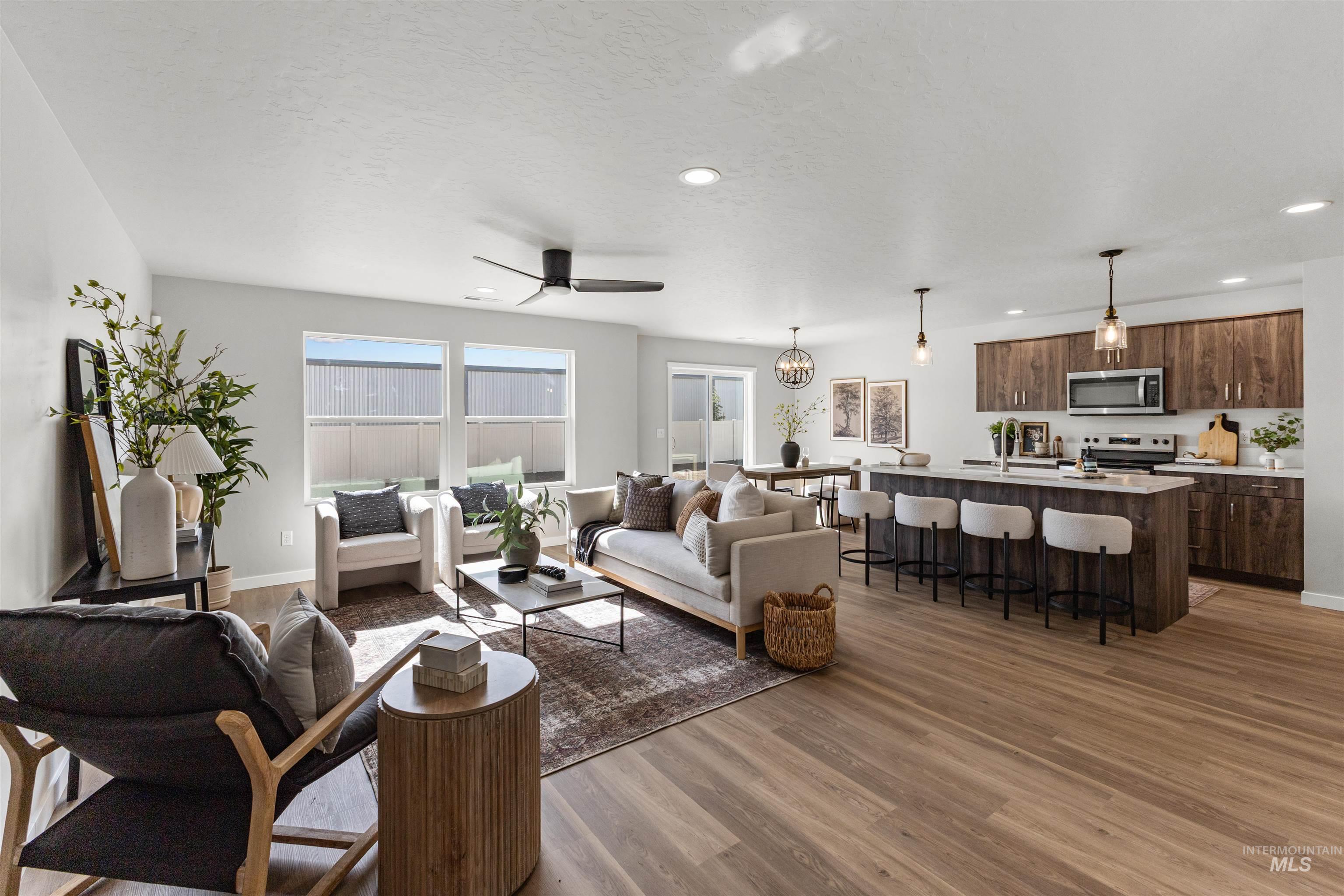2534 West Fallon Loop Nampa, ID 83651 - Photo 4 of 28 Living area with ceiling fan, dark wood-style floors, and recessed lighting