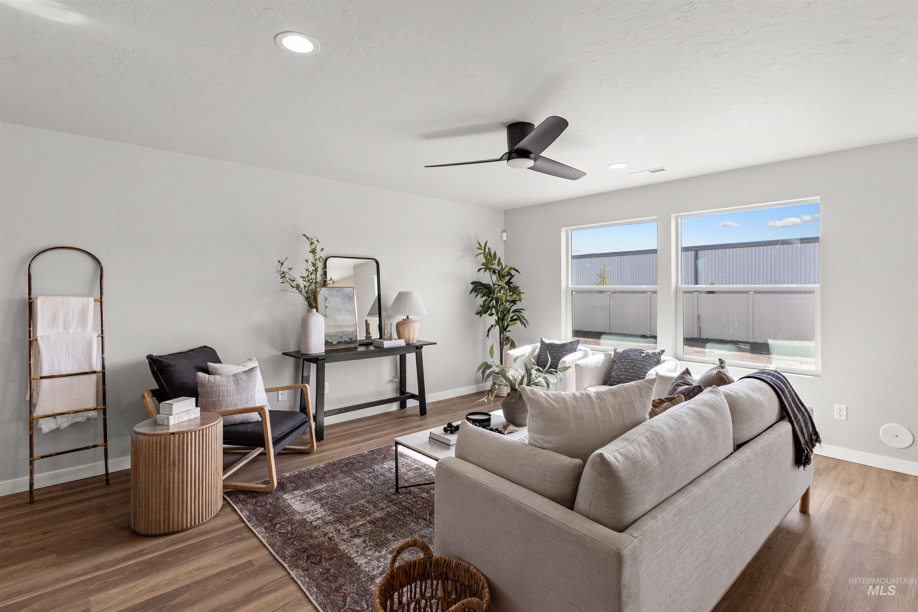 2534 West Fallon Loop Nampa, ID 83651 - Photo 5 of 28 Living room featuring wood finished floors, a ceiling fan, and recessed lighting