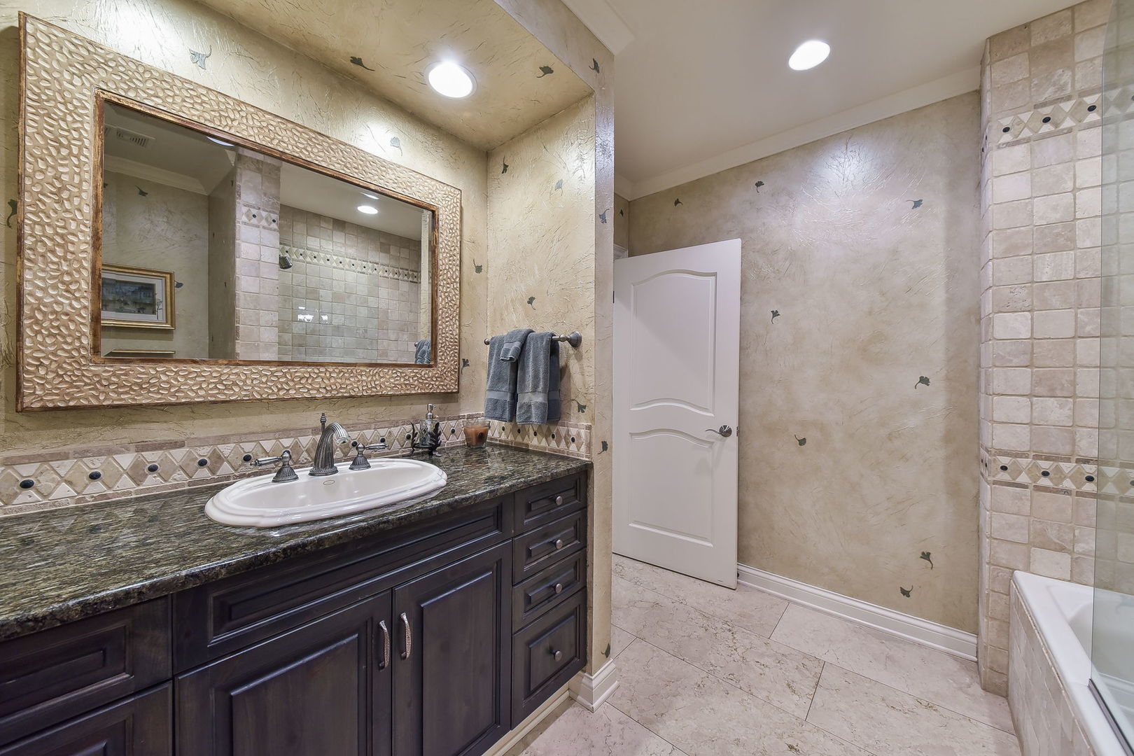 6N197 Denker Road St. Charles, IL 60175 - Photo 47 of 73 a bathroom with a granite countertop sink a mirror a shower and a bathtub