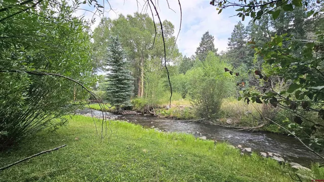 a backyard of a house with a yard and outdoor seating