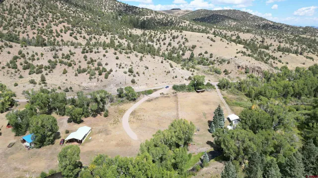 an aerial view of a house with a mountain
