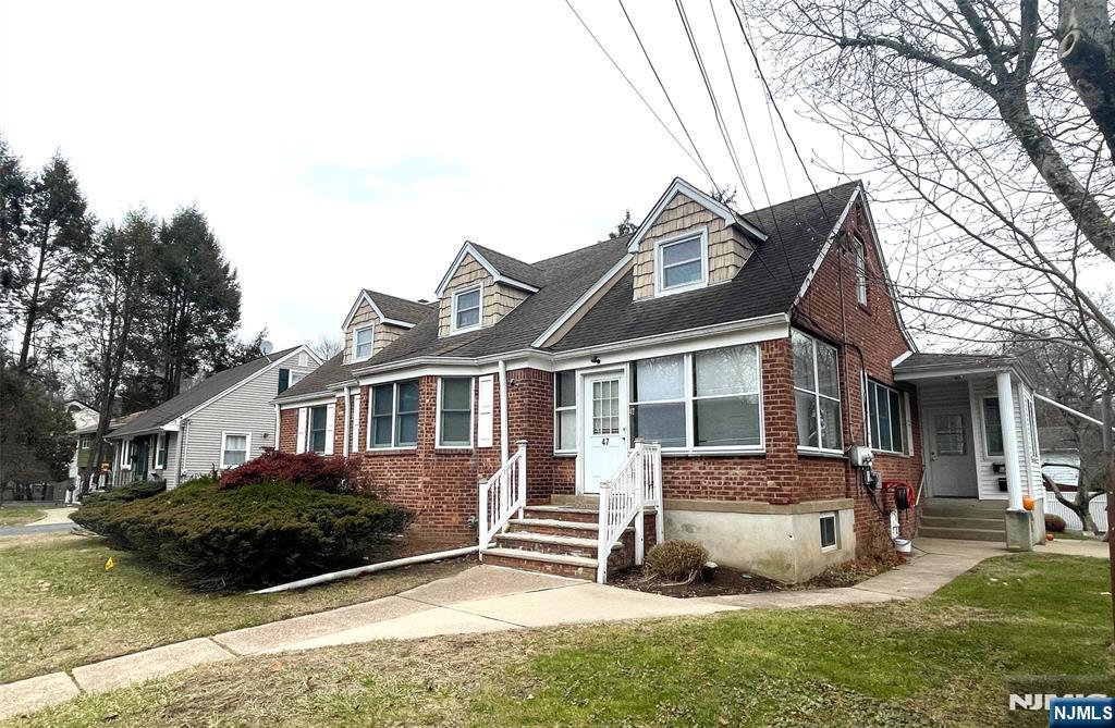47-49 Fairview Avenue, Unit A Closter, NJ 07624 - Photo 1 of 19 a front view of a house with a yard